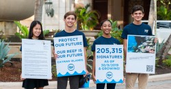 Cayman Students present a global anti-dredging petition to Royal Caribbean President