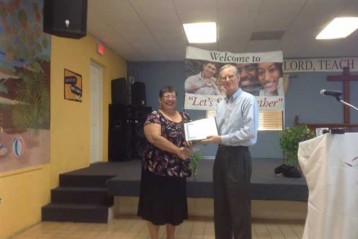 Deputy Director Mrs Paulette Conolly-Bailey and an Elder of the Elmslie Memorial Church.