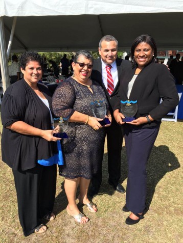 Employees receiving long service awards from Deputy Governor Franz Manderson.  Left to right - Martha Watler, Paulette Conolly-Bailey & Norma McField